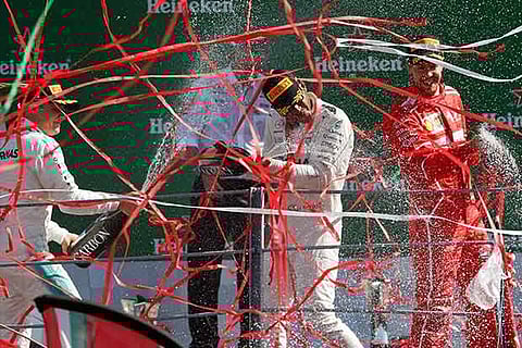 Lewis Hamilton, winner of the Italian GP, celebrates with Valtteri Bottas and Sebastian Vettel