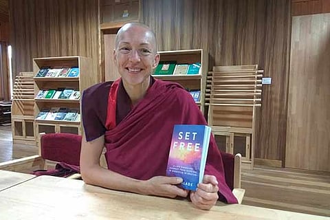 Emma Slade aka Ani Pema Deki with a copy of her book