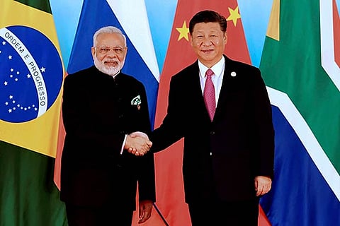 Chinese President Xi Jinping, shakes hands with Indian PM Narendra Modi at the BRICS Summit