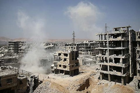 Smoke rises at a damaged site in Ain Tarma, eastern Damascus suburb of Ghouta, Syria