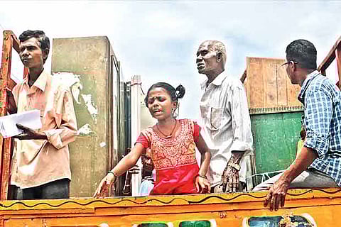 A schoolgirl calls out while her family is being evicted on Thursday