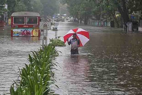 A man wades through a water-logged road during rains in Mumbai, August 29, 2017.