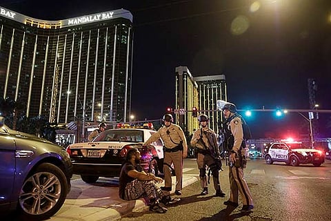 Police officers stand at the scene of a shooting near the Mandalay Bay resort and casino