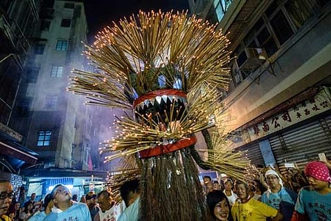 A participant holds the head of a ?fire dragon? as he takes part in Tai Hang ?fire dragon? event