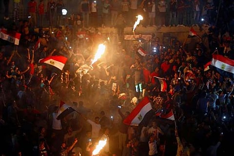 Egyptians celebrate their victory in a match against Congo that qualifies them for the World Cup