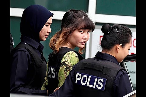 Doan Thi Huong is escorted by police as she leaves a laboratory in Petaling Jaya, Malaysia