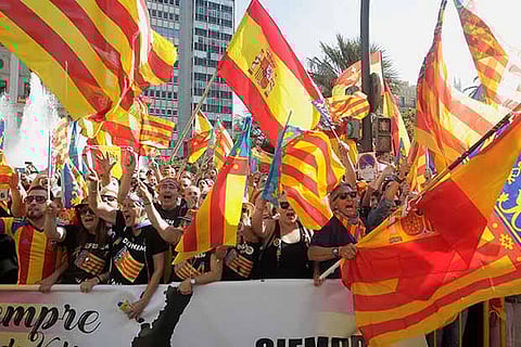 Right-wing demonstrators waving Spanish and Valencian flags insult local leftist politicians