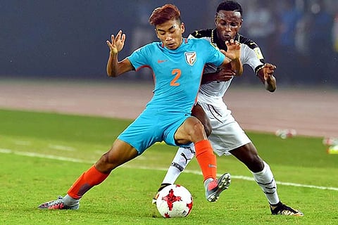 A Ghana defender tries to tackle India?s Boris Thangjam (2) on Thursday