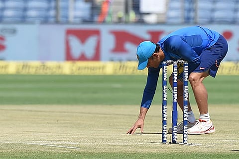 MS Dhoni inspects the Pune wicket before the second ODI
