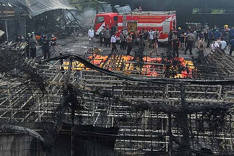 Indonesian forensic policemen work after a fire disaster in Tangerang Kota