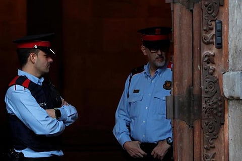 Catalan regional police officers stand guard outside the Catalan regional government headquarters