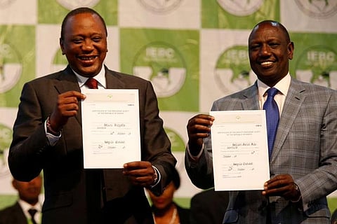 Incumbent Prez Kenyatta (L) reacts after he was announced winner of the repeat presidential election