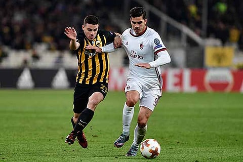 AC Milan?s Andre Silva (right) fights for the ball with AEK?s Kostas Galanopoulos