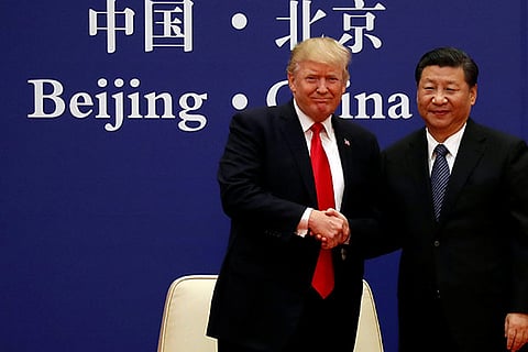 US President Trump and China's President Xi Jinping shake hands