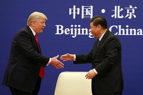 US President Donald Trump, and Chinese President Xi Jinping prepare to shake hands