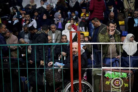 Palestinians wait for travel permits to cross into Egypt