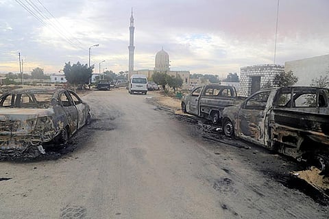 Damaged vehicles are seen after a bomb exploded at Al Rawdah mosque in Egypt