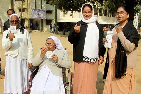 Allahabad : Nuns showing ink-marked fingers after casting vote in the second phase of UP Polls.(PTI)