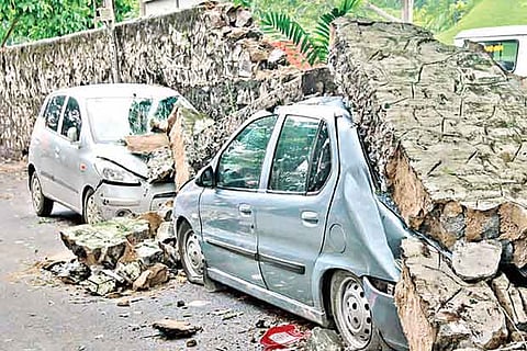 The compound wall of Semmozhi Poonga collapsed on Monday morning with huge chunks falling on two car