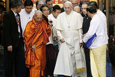 Pope Francis arrives with Bhaddanta Kumarabhivasma, chairman of state Sangha Maha Nayaka Committee