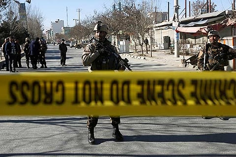 Afghan security forces keep watch at the site of a suicide attack in Kabul, Afghanistan