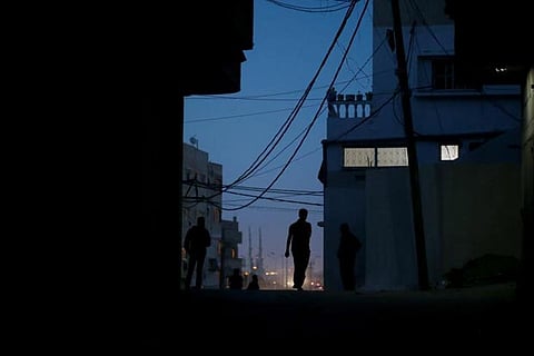 A Palestinian man walks during power cut at Shati refugee camp in Gaza City