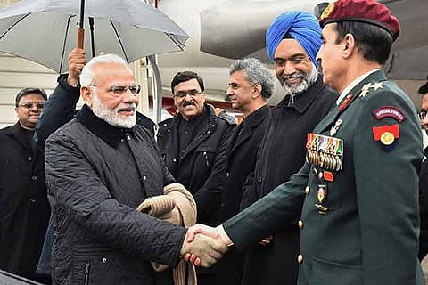 Prime Minister Narendra Modi greets the officials on his arrival at Zurich International Airport