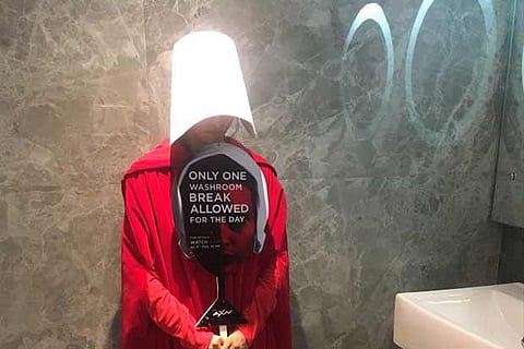 A woman holding a placard with a message