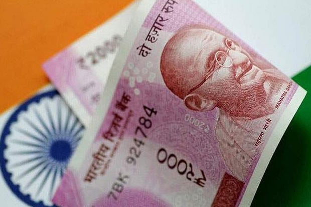Rupee slumps 30 paise to close at record low of 74.06
