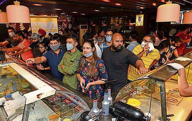 people buying ice cream in store 