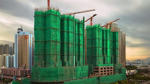 Green clothes beside under construction building