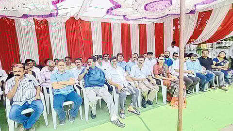 Members of the Diamond group sitting in front of the collector's office.