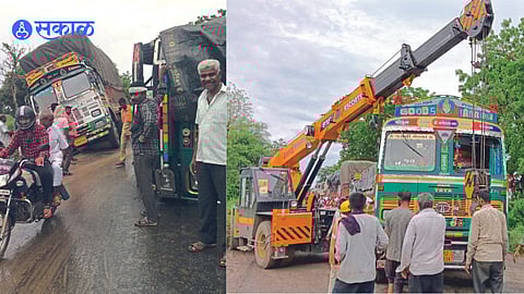 The overturned truck near the petrol pump and the truck stuck in the site