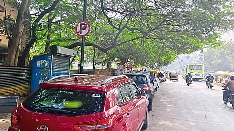 Vehicles are parked on the footpath. This view from CBS Street.