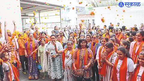 Sakal Hindu Samaj coordinator showering flowers on women who came to watch the movie 'The Kerala Story' at Movie Max on College Road.