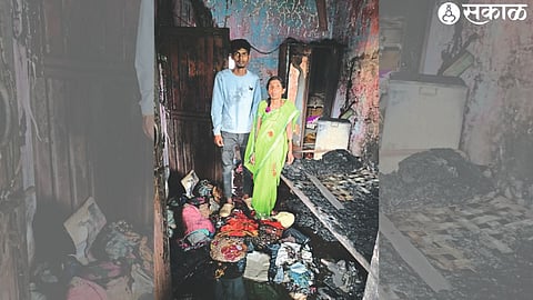 Nanda Shinde looking at the condition of the house that was gutted by fire at Shivajinagar HUDCO.