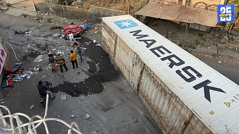 Container falls from bridge