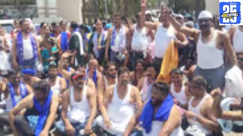 Protestors stage a half-naked demonstration outside the Republican Party’s district office, demanding land for a Buddhist monastery.