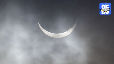 A breathtaking view of the 2025 partial solar eclipse as the moon partially obscures the sun, creating a stunning crescent-shaped glow in the sky.

