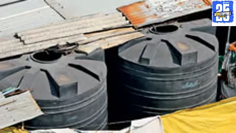 Health department officials during a dengue inspection in slum areas where larvae were found in 26 barrels across 22 homes.