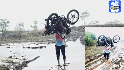 Shocking scene from Maharashtra: Youth lifts his motorcycle through muddy, impassable road.