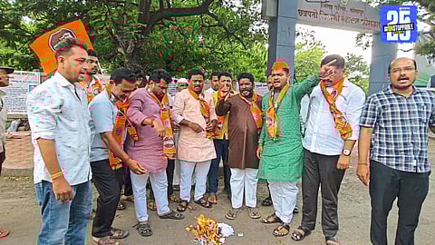 "MNS workers burn ordinance in protest against Hindi imposition in Maharashtra; demand equal language policies across states."