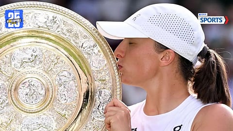 Poland’s Iga Swiatek lifts her first Wimbledon trophy