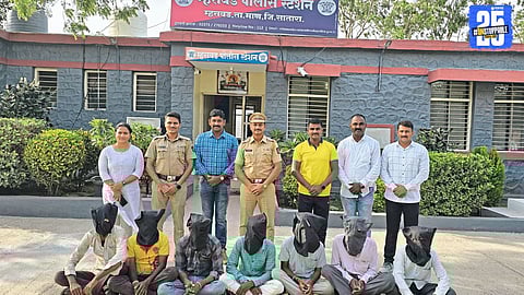 Mhaswad Police with seized gambling material and cash after raiding a local den; seven suspects arrested.