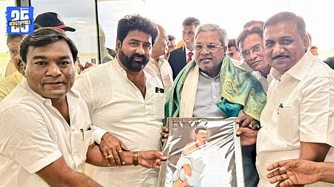 CM Siddaramaiah receives Basaveshwara statue from Congress during a development inauguration event.