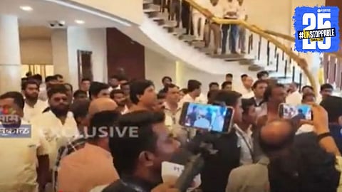 Security personnel intervene as supporters of Gopichand Padalkar and Jitendra Awhad clash in the lobby of Maharashtra Vidhan Bhavan.

