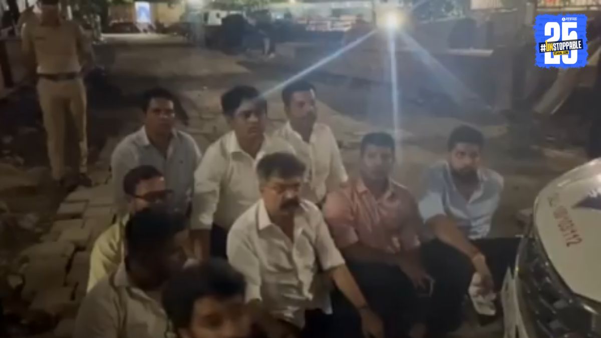 NCP MLA Jitendra Awhad stages a late-night sit-in protest in front of a police vehicle outside Vidhanbhavan, alleging bias and injustice by the police in arresting his assaulted supporter instead of the attackers.