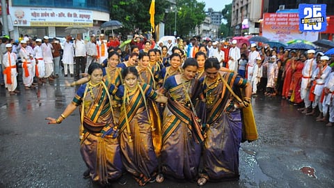 Devotees drenched in rain yet filled with devotion during Sant Namdev Maharaj’s Dindi procession in Solapur.