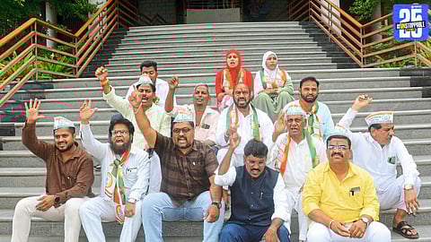 “NCP workers stage sit-in outside Collector's Office demanding resignation of Kokate.”