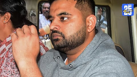 Former MP Prajwal Revanna being escorted by female SIT officers at Bengaluru airport after his extradition from Germany, following multiple rape allegations.
